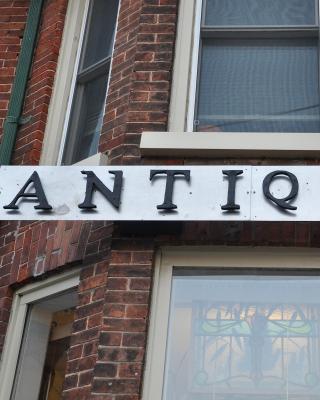 Metal and White Antiques Sign